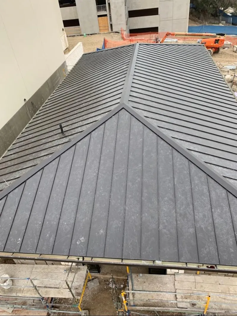 Commercial metal roof construction with crane equipment in Fort Myers Shores