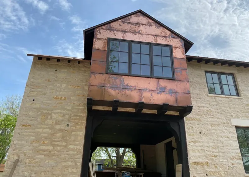 Copper metal panel facade on a stone building for Skylight Installation in Fort Myers Shores